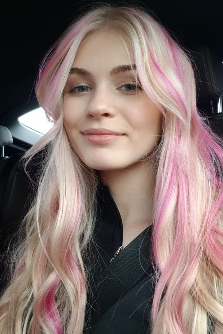 Blonde hair with hot pink face-framing streaks, front view