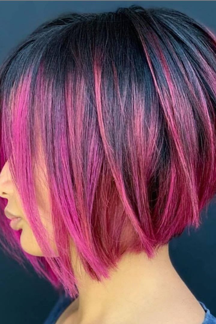 Dark bob haircut with pink peekaboo underlayer, side view