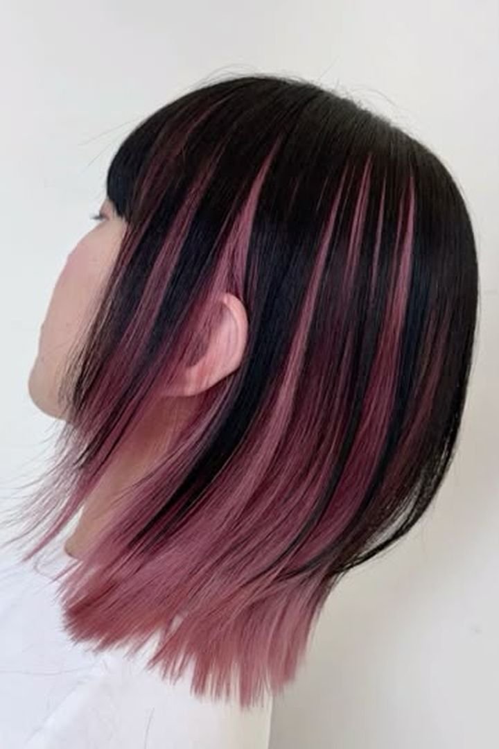 Fine delicate pink ribbon stripe near the face on dark hair