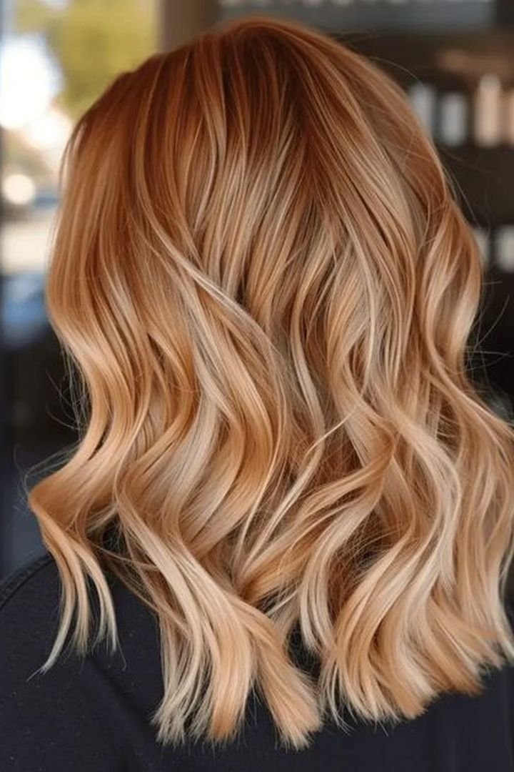 Honey copper blonde hair in soft curls
