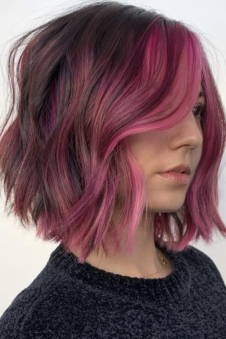 Bob with bangs and dark pink peekaboo underlayer