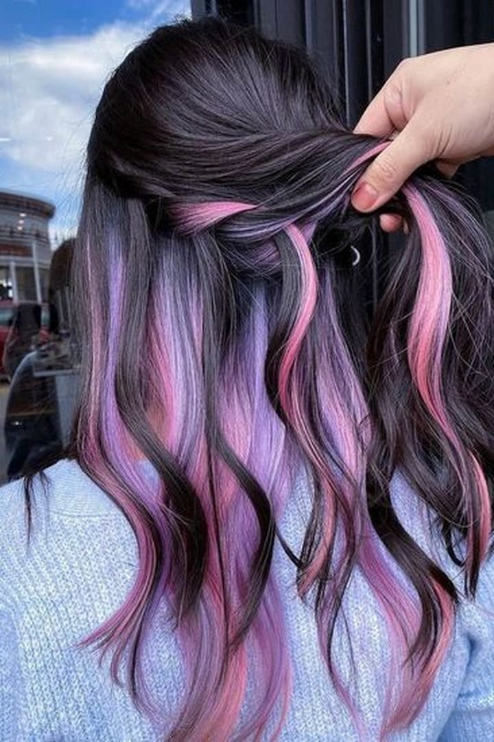 Pink ribbon streaks woven through long dark hair