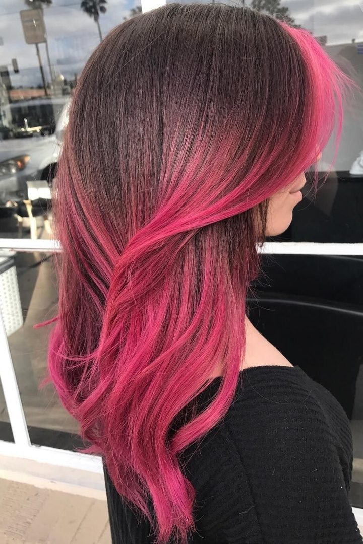 Long dark pink peekaboo underlayer on dark hair, side view