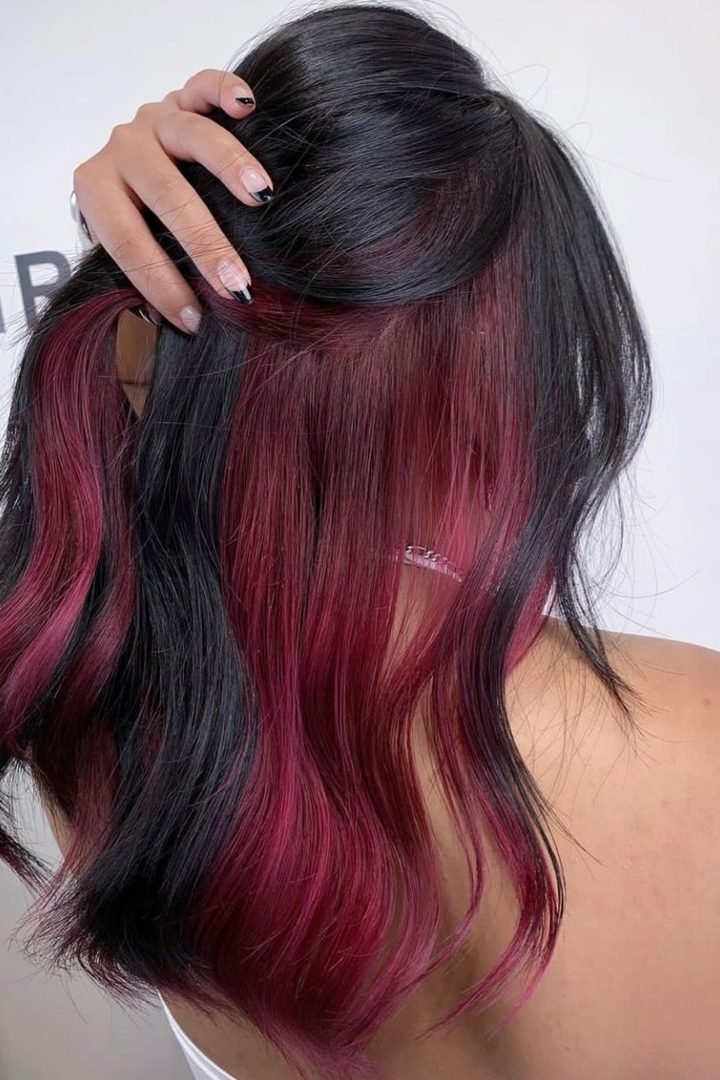 Wine pink underlayer revealed by lifting dark hair