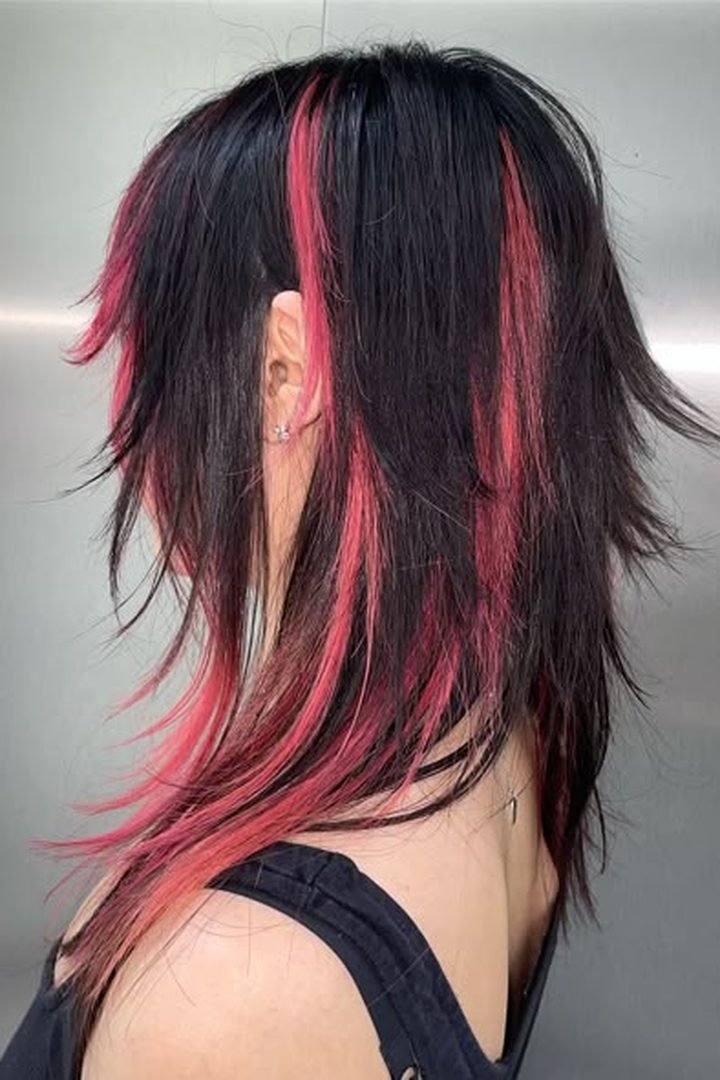 Red pink peekaboo on edgy dark shag haircut