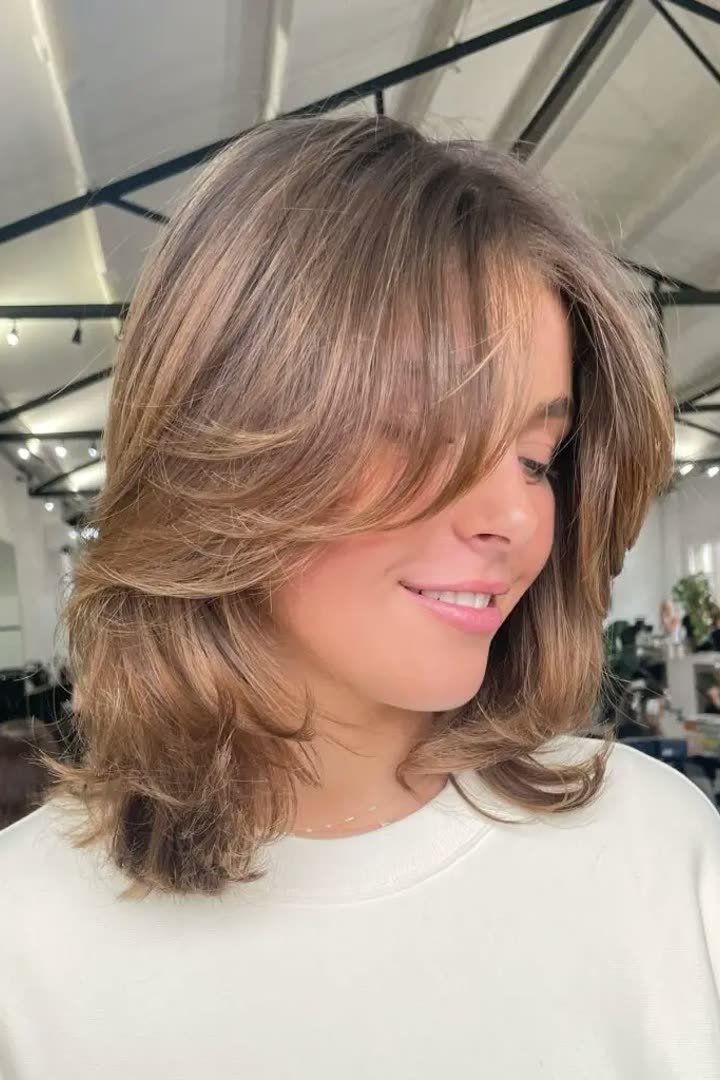 Polished blowout kitty cut with glossy bouncy layers