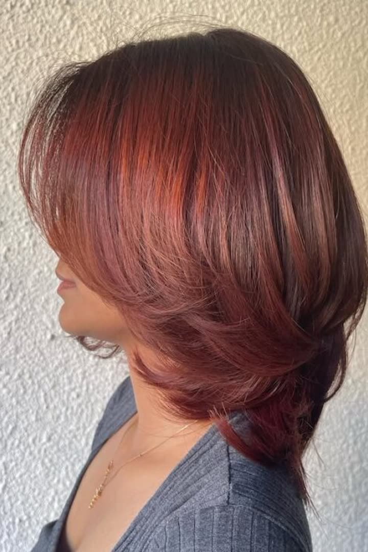 Auburn kitty cut with rich red-brown tones