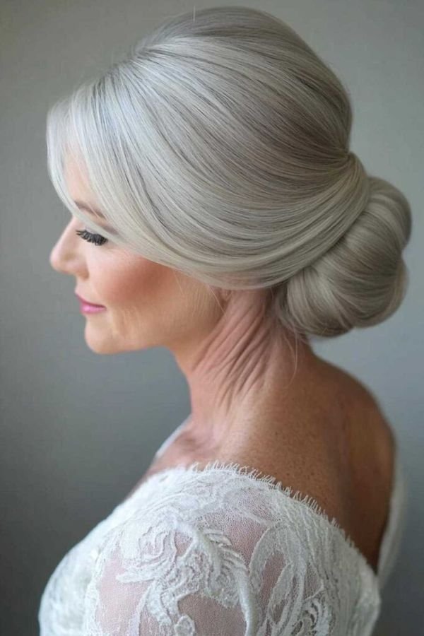 Silver-grey chignon on an older woman, back profile view