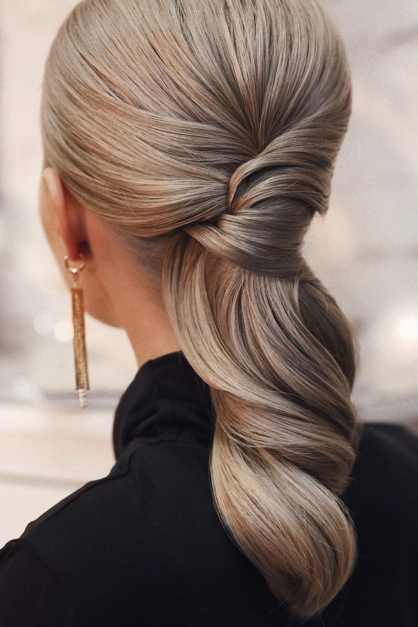 Low twisted ponytail with silk ribbon for New Year's Eve