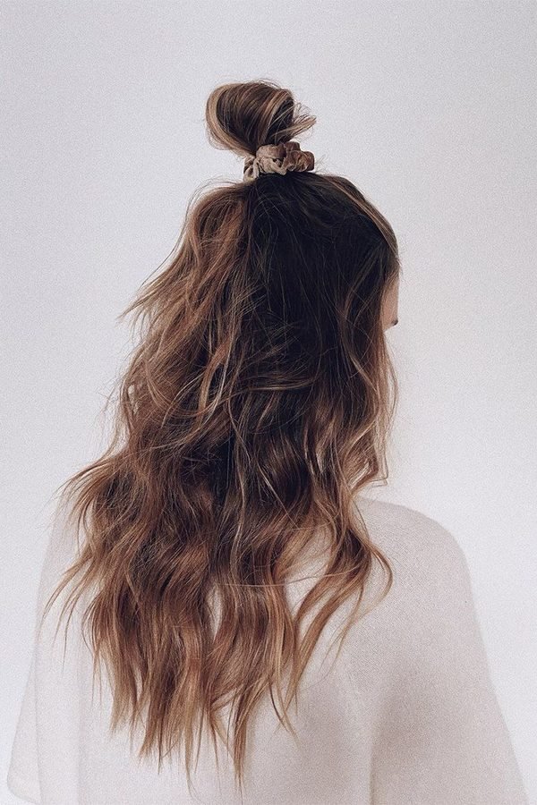 Half-up bun with gold scrunchie for NYE party hairstyle