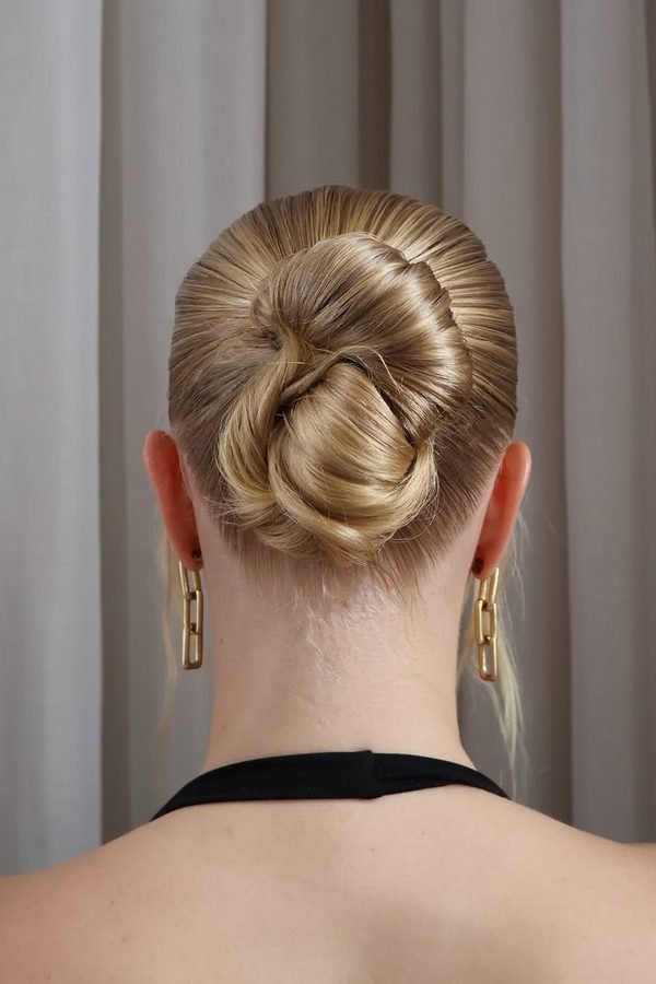 Slicked bun with glitter roots for bold New Year's Eve party look