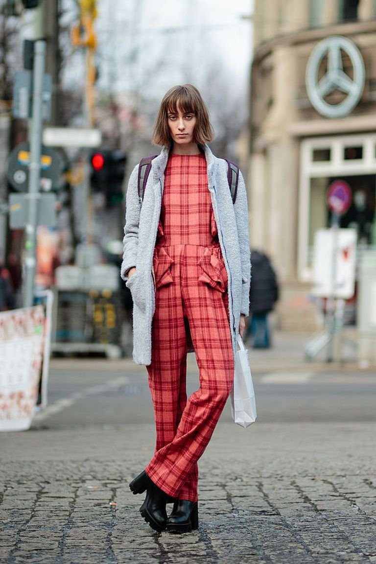 Woman wearing a plaid winter outfit with a cozy coat, one of the best plaid winter outfits for women