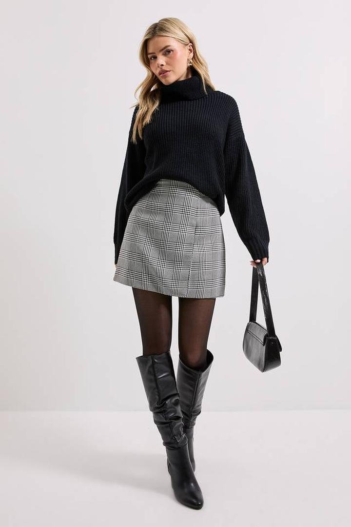 Black turtleneck sweater with a grey plaid mini skirt, black tights and knee-high boots