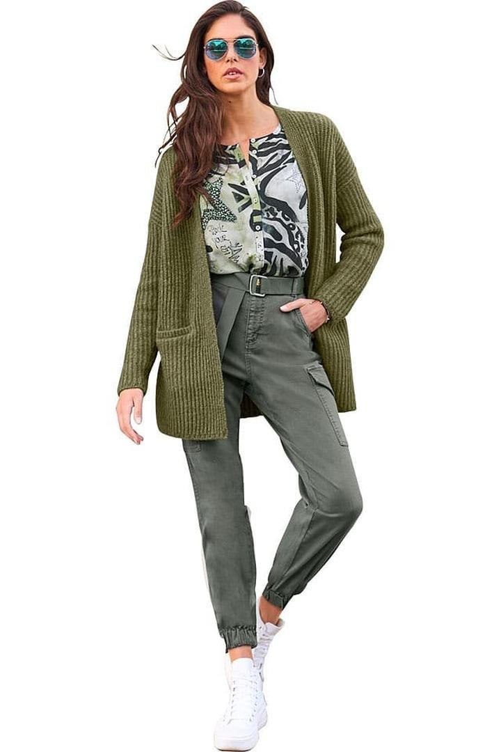 Olive green cargo trousers with a ribbed knit cardigan and white trainers