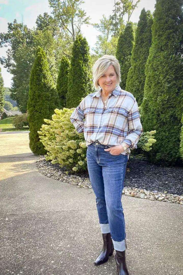 Blue and brown plaid flannel shirt with cuffed jeans and dark booties