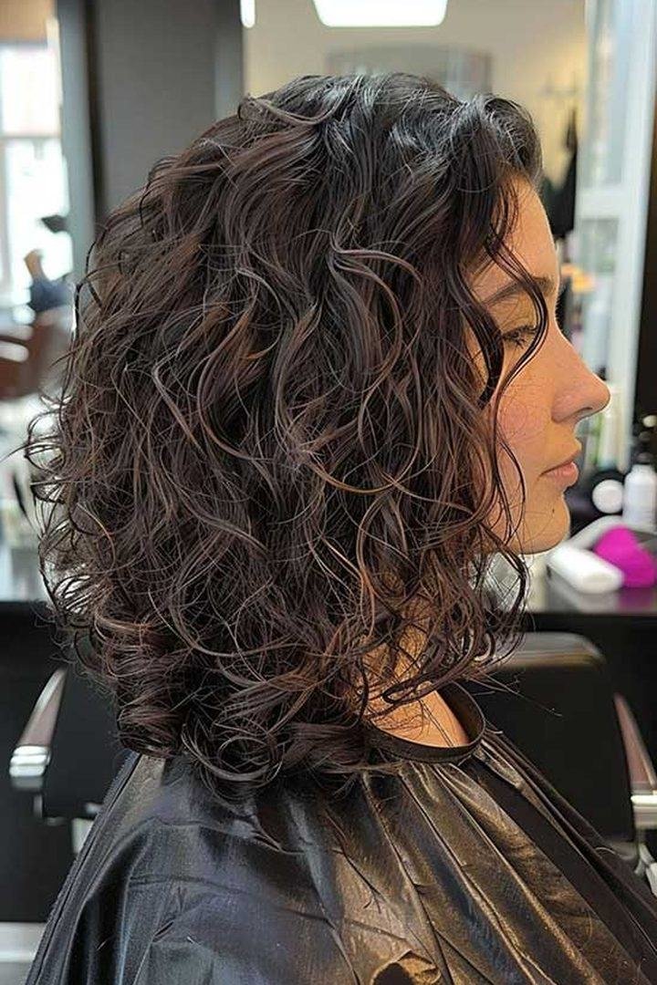 Side view of a curly long bob haircut
