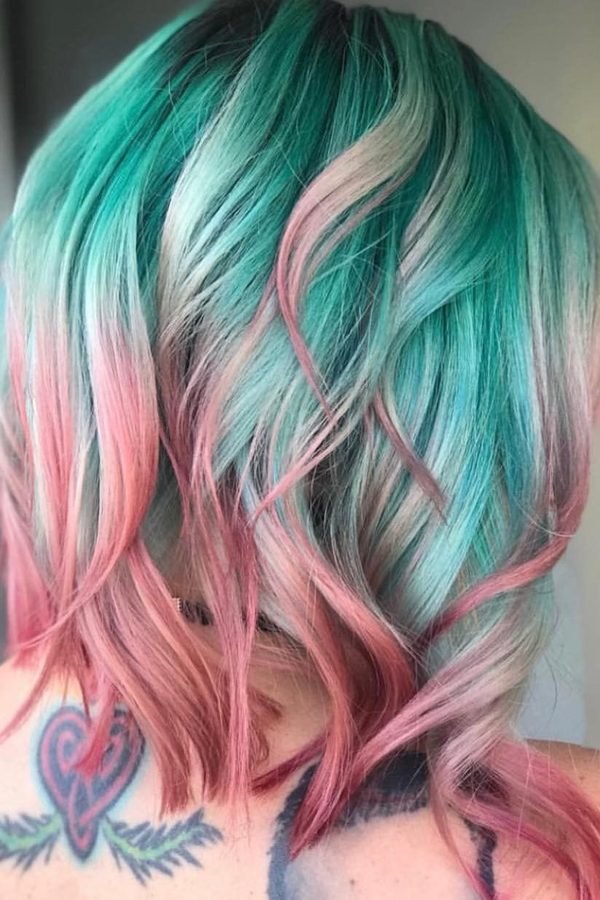 Soft pastel teal and pink waves on long hair