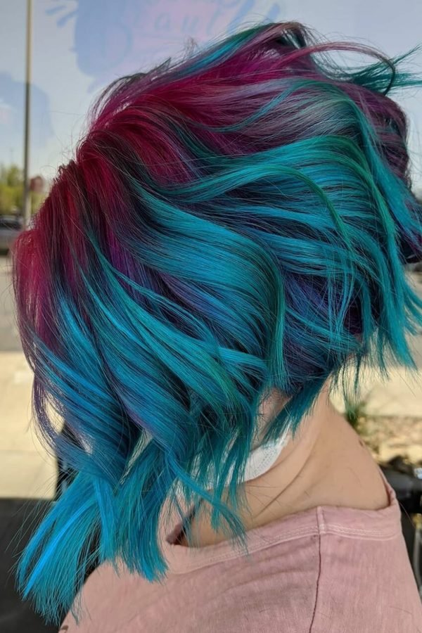 Teal and pink hair colour on a chin-length bob