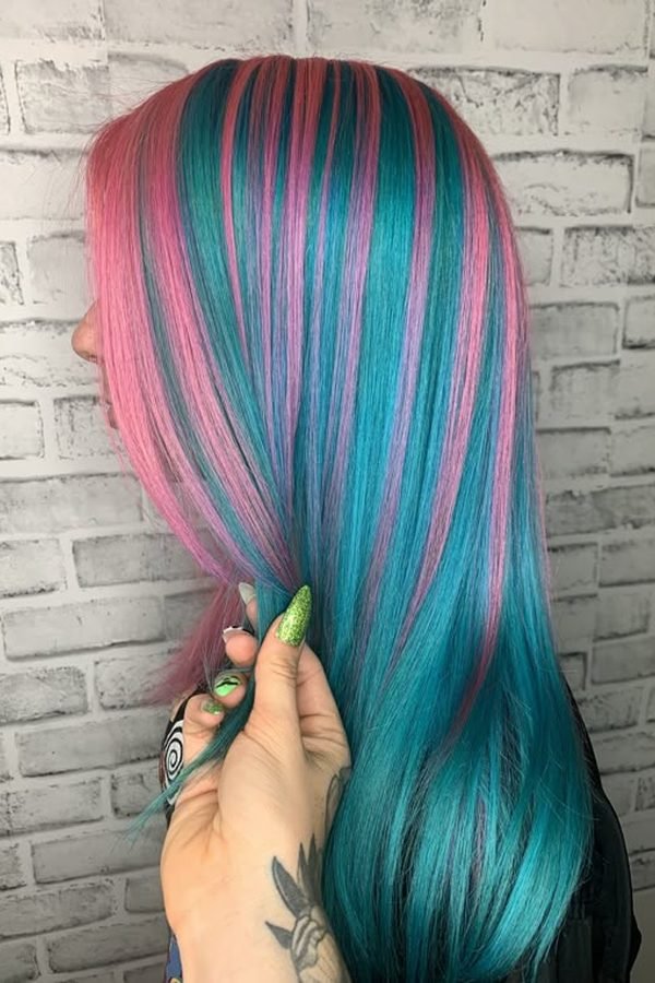 Chunky teal and pink streaks through dark blonde hair