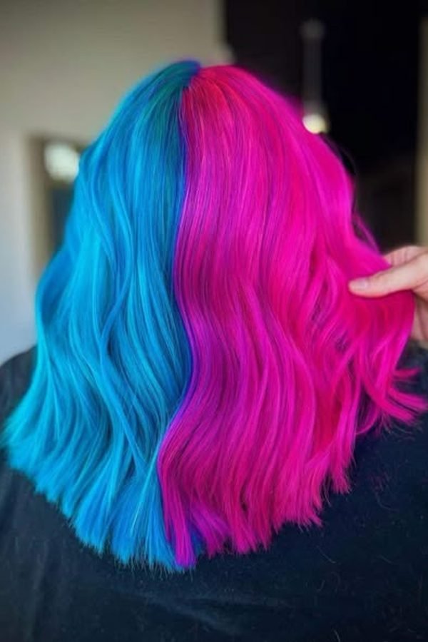 Split teal and hot pink colour on layered long hair
