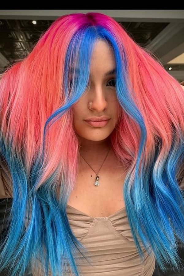 Coral pink and teal split-dyed hair