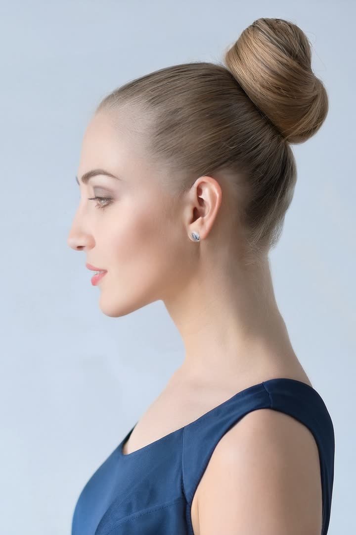 Sleek high ballerina bun hairstyle for a winter formal
