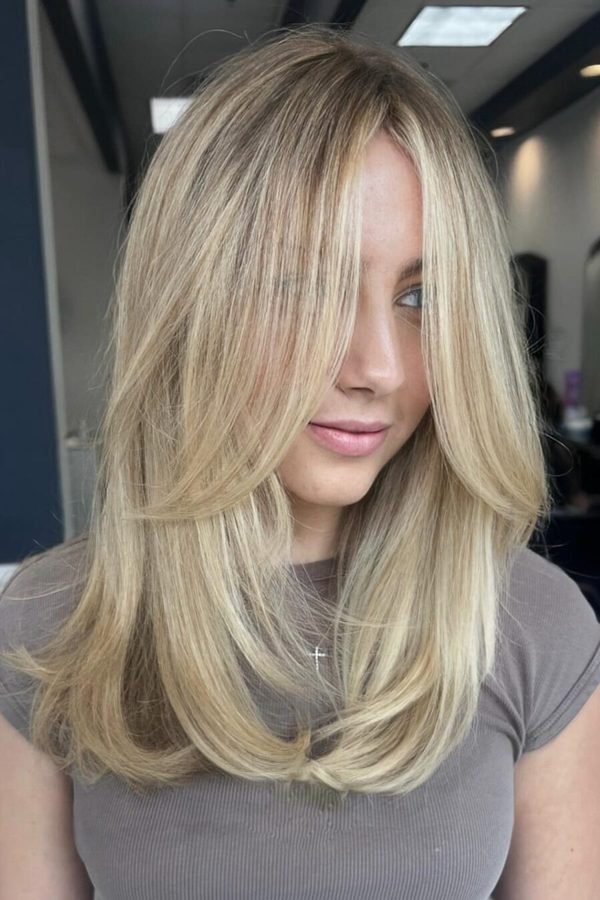 Buttery blonde hair color, creamy golden lengths with soft layers