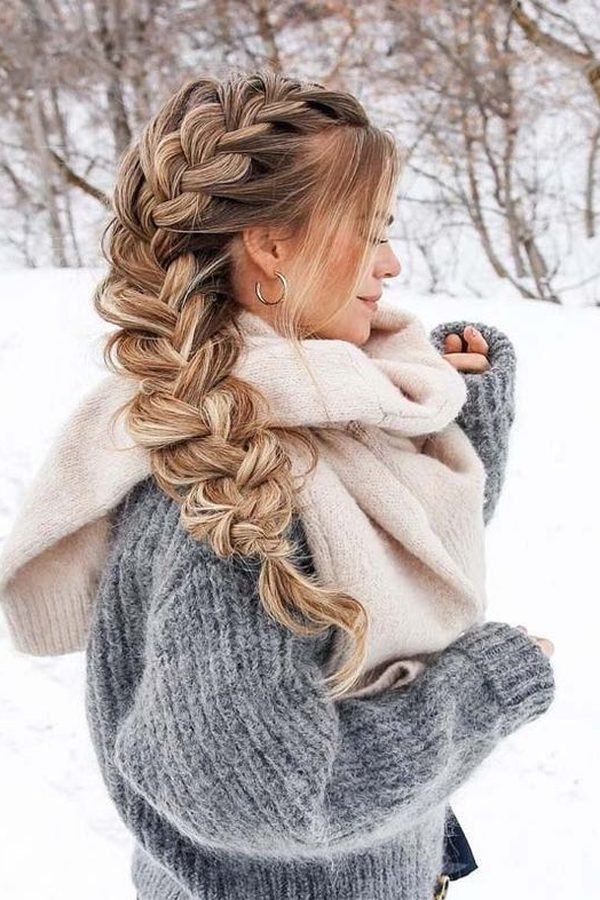 Loose side swept braid with a cream scarf in the snow — one of the most practical winter hairstyles