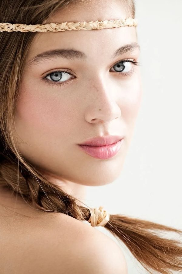 Braided headband worn across the forehead with loose hair